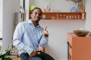 Portrait of Smiling businessman sitting on a desk in an office.