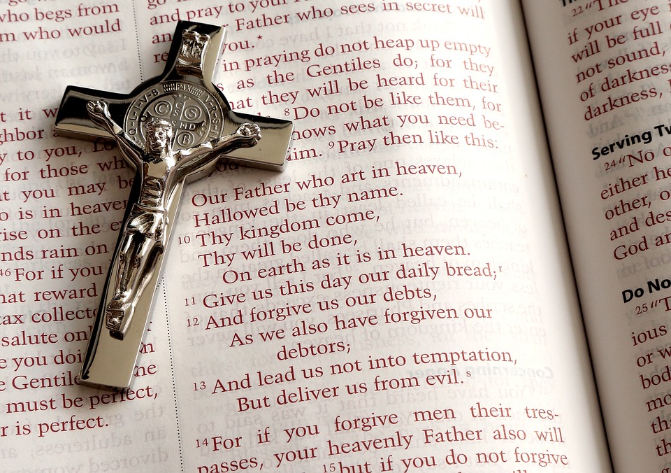 Crucifix and Lords Prayer in Bible