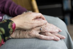 Image of a Young Hand Holding an Elderly Hand. Hands Young and Old
