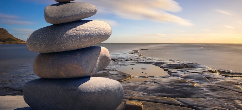 A calming image of the ocean with stones stacked upon each other. 