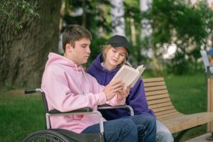 A couple reading a book in the park 