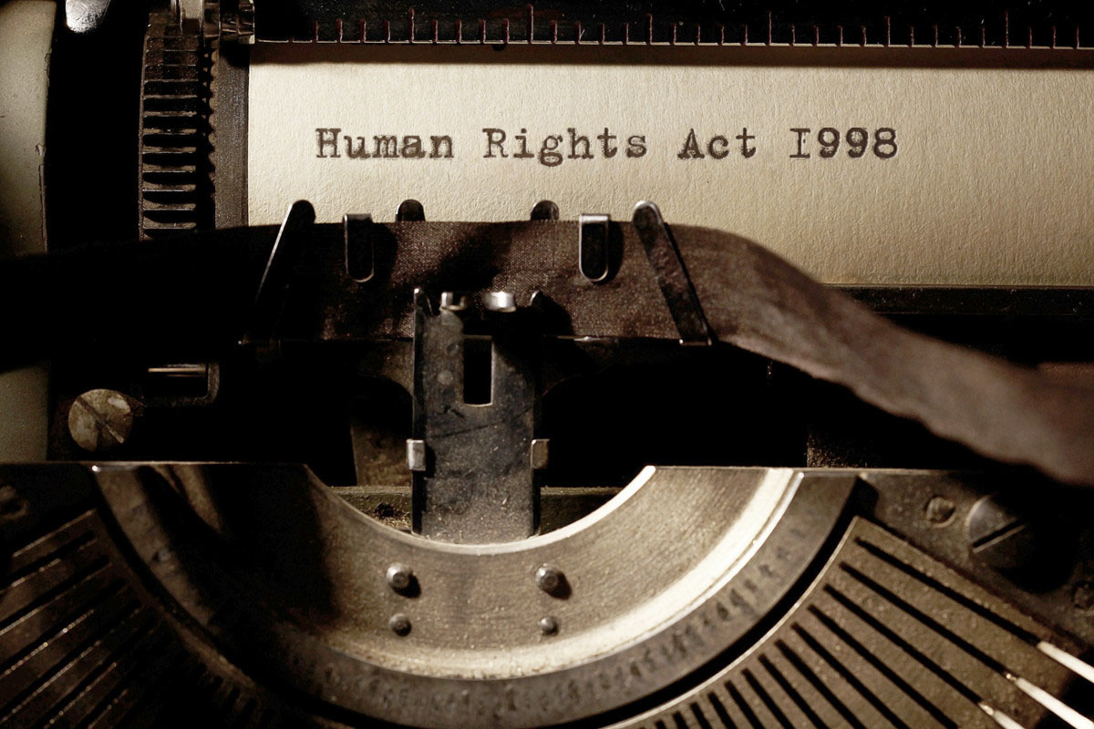 Image Description: Brown & Cream Coloured Image Depicting a Typewriter With Wording "Human Rights Act 1998" Typed On Paper. Image Credit: PhotoFunia.com Category: Vintage Typewriter.
