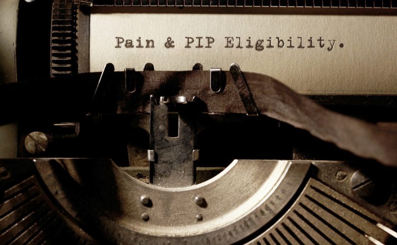 Image Description: Brown & Cream Coloured Image Depicting a Typewriter With Wording "Pain & PIP Eligibility". Typed On Paper. Image Credit: PhotoFunia.com Category: Vintage Typewriter.