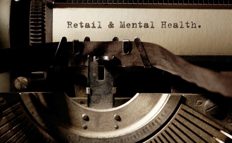 Image Description: Brown & Cream Coloured Image Depicting a Typewriter With Wording "Retail & Mental Health". Typed On Paper. Image Credit: PhotoFunia.com Category: Vintage Typewriter.