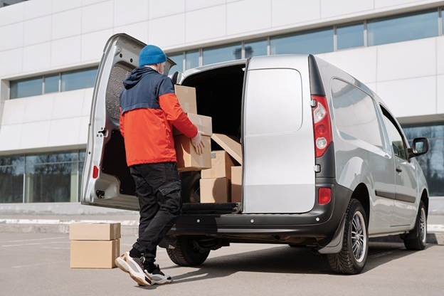 Alt: mover packing moving van with boxes

Caption: Avoiding moving scams starts with researching and choosing the right company. Image Credit: https://www.pexels.com/photo/a-man-in-a-jacket-loading-boxes-in-a-van-4391486/