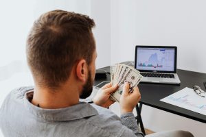 https://www.pexels.com/photo/a-man-holding-bank-notes-5717782/
