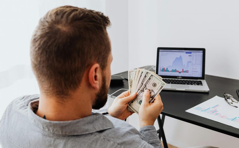 https://www.pexels.com/photo/a-man-holding-bank-notes-5717782/