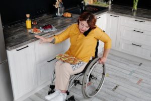 woman sitting in a wheelchair in the kitchen