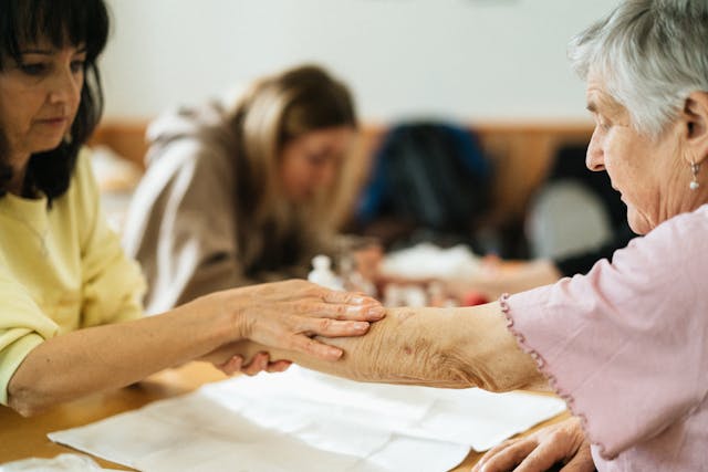 Image Description: A woman touching the arm of an elderly lady. Image Credit: https://www.pexels.com/photo/a-woman-touching-an-arm-18429306/ Jsme MILA