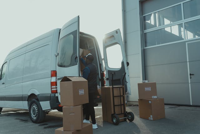 Image Description: Person loading boxes into a van . Image Credit: https://www.pexels.com/photo/delivery-man-getting-packages-from-a-van-6169177/