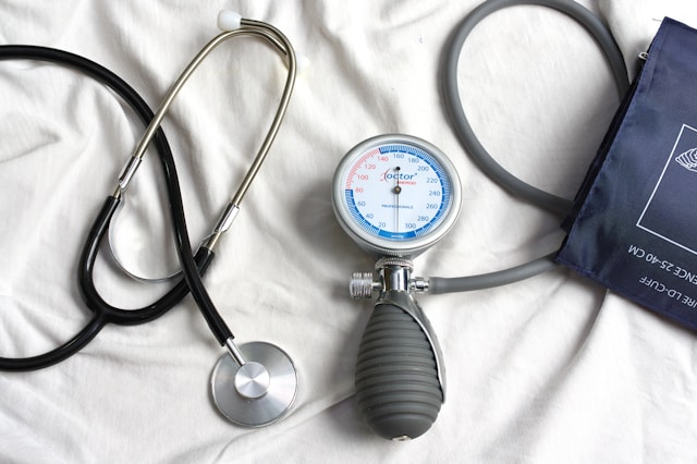 Image Description: Medical equipment on a white sheet. Image Credit: https://unsplash.com/photos/a-stethoscope-laying-on-top-of-a-bed-next-to-a-medical-bag-f0h8EIdTXWo