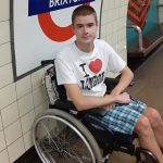 Image Description: Liam Virgo, in a wheelchair on the Brixton Underground Tube Station London. Image Credit: Liam Virgo Copyright 2025 All Rights Reserved.