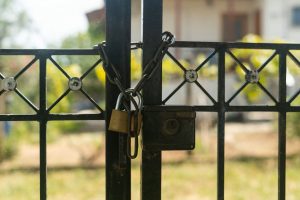 Image Description: Padlock On Gate With A White House In Background. Image Source: https://unsplash.com/photos/a-padlock-on-a-gate-with-a-house-in-the-background-cwkWh_4Fb-M?utm_source=unsplash&utm_medium=referral&utm_content=creditCopyText Image Credit: https://unsplash.com/@avdellidisfotis?utm_source=unsplash&utm_medium=referral&utm_content=creditCopyText