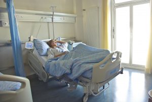 Photo of woman lying in a hospital bed. Image Source: Pexels.com Image Credit: Andrea Piacquadio