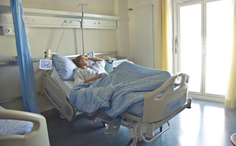 Photo of woman lying in a hospital bed. Image Source: Pexels.com Image Credit: Andrea Piacquadio