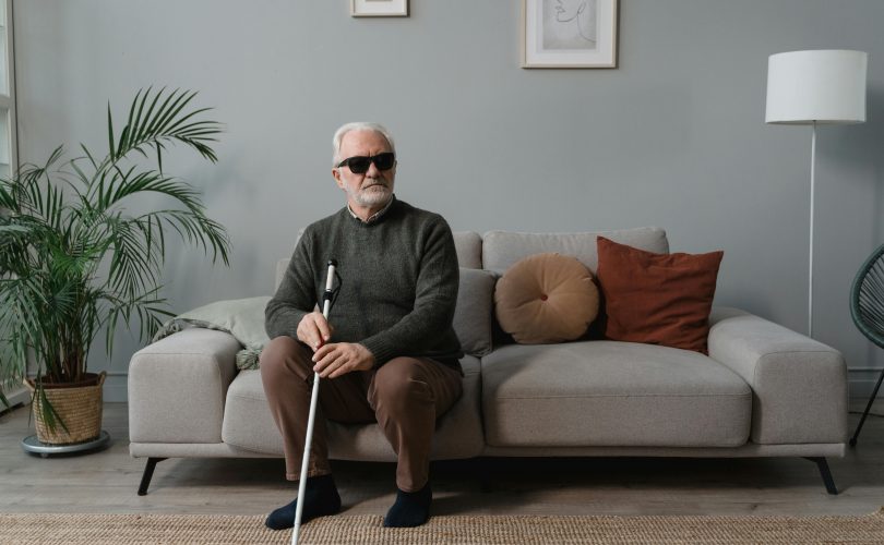 Image Description: A blind man wearing sunglasses, while holding his white cane. Image Credit: Tima Miroshnichenko Image Source: https://www.pexels.com/photo/a-blind-man-wearing-sunglasses-while-holding-his-white-cane-6609416/
