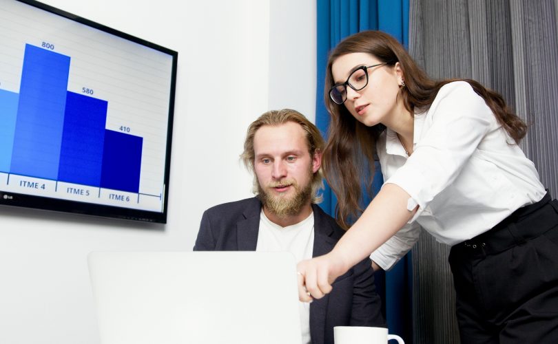 • Image Description: A woman standing beside a man in front of a white laptop • Image Credit: Artem Podrez - https://www.pexels.com/@artempodrez/ • Image Source: https://www.pexels.com/photo/a-woman-standing-beside-a-man-sitting-in-front-of-a-white-laptop-5716011/