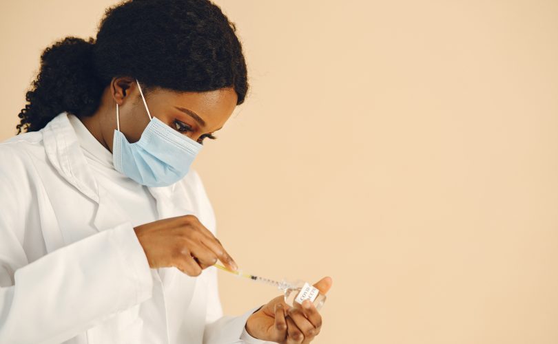 Image Description: Woman In White Lab Gown Holding Syringe Image Credit: Gustavo Fring: https://www.pexels.com/@gustavo-fring/ Image Source: https://www.pexels.com/photo/woman-in-white-lab-gorn-holding-syringe-8770698/