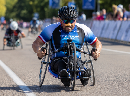 Disabled Person On An Adaptive Bike: Image Credit: The UK Website Designers Group. Copyright 2026