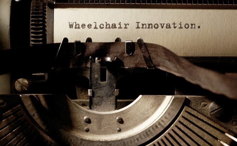 Image Description: Brown & Cream Coloured Image Depicting a Typewriter With the wording "Wheelchair Innovation" Typed On Paper. Image Credit: PhotoFunia.com Category: Vintage Typewriter.