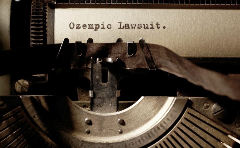 Image Description: Brown & Cream Coloured Image Depicting a Typewriter With the wording "Ozempic Lawsuit" Typed On Paper. Image Credit: PhotoFunia.com Category: Vintage Typewriter.