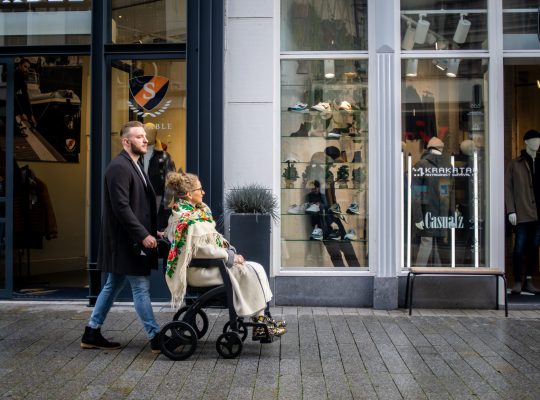 Image Description: Man pulling woman in wheelchair Image Credit: Rollz International: https://www.pexels.com/@rollz/ Image Source: https://www.pexels.com/photo/man-pulling-woman-in-wheelchair-19903419/